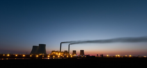 Industrial Power Plant at Dusk with Smoke Emissions