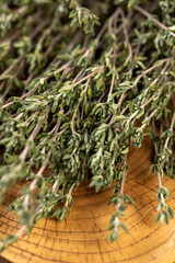 thyme spices bound together for use in cooking and folk medicine, thyme spices lying on a wooden...