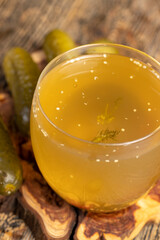 cucumber marinade in a glass and pickled crispy cucumbers on the table, cucumbers marinated in water on the table