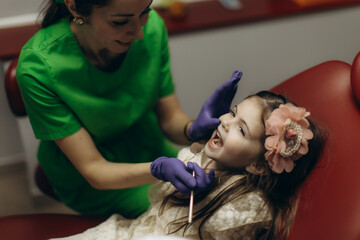 Young Girl Visiting Dentist For Routine Checkup in Modern Dental Office
