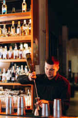Bartender Preparing a Drink at a Stylish Modern Bar Counter