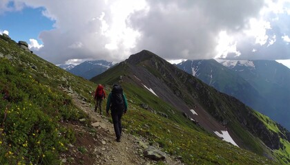 Fototapeta premium Travel photo of a couple hiking in the mountains with backpacks under dramatic clouds, highlighting adventure, exploration, outdoor lifestyle, nature travel, and scenic wilderness.