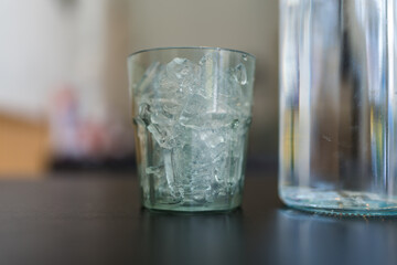 A glass filled with ice on table
