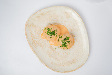 Exquisite dish featuring velvety sauce and finely chopped herbs, inviting a savory experience
