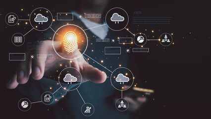 Businessman touching a glowing fingerprint on a virtual interface for biometric authentication to access cloud data and network systems, symbolizing cybersecurity and technological innovation.