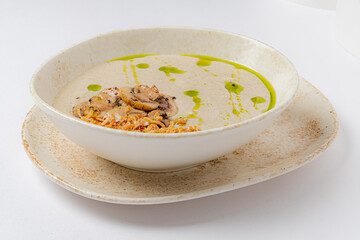 Creamy mushroom soup with sautéed mushrooms and crispy onions offers a cozy delight