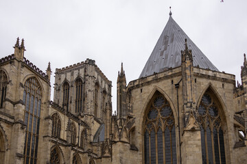 Fototapeta premium Exterior view of a historic Gothic-style cathedral featuring tall towers, pointed arches, and stained glass windows