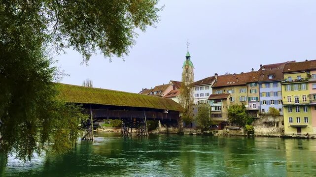 The Covered Historical Wood Bridge Holzbr&uuml;cke over River Aare and Old Town in Autumn in Olten, Canton Solothurn, Switzerland.