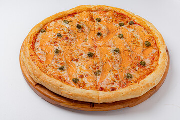 A freshly made salmon pizza features rich flavors and garnishes topped with capers and herbs
