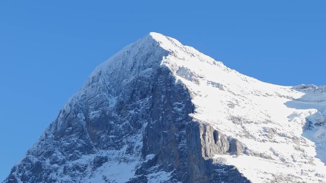 Beautiful Snowcapped Mountain Peak Eiger North Face at 3970 Meter High in a Sunny Winter Day with Blue Clear sky in Grindelwald, Kleine Scheidegg, Bernese Oberland, Bern Canton, Switzerland.