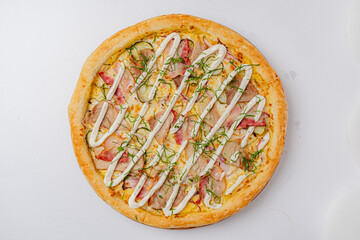 Enjoy gourmet pizza topped with savory meats, fresh herbs, and creamy sauce
