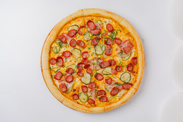 A beautifully crafted pizza boasts a crust lined with juicy sausage, pickles, and vibrant herbs