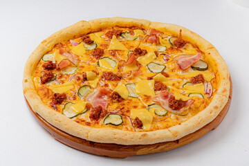 Cheesy pizza adorned with ham, pickles, and toppings fresh from the oven is perfect for sharing