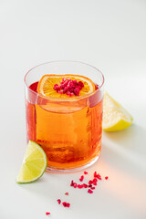 A vibrant cocktail with orange, lime, and raspberries brightens any occasion