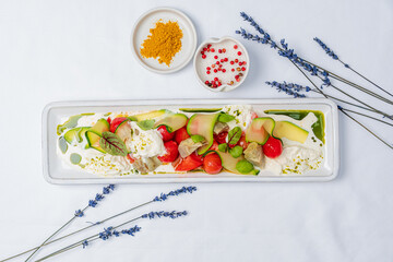 Vibrant fresh vegetables and creamy elements arranged to evoke summer freshness