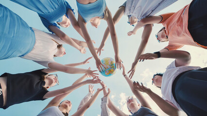 Group of students reaching for a globe, symbolizing their commitment to environmental protection and global citizenship