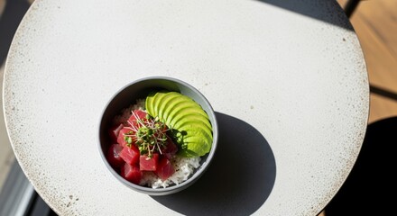 Delicious and healthy poke bowl with tuna, avocado, rice, and microgreens.  A vibrant and fresh meal, perfect for a healthy lunch or dinner.  Great for restaurant menus or food blogs.