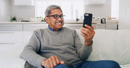 Happy, senior man and phone on sofa for watching online video, social media post or reading ebook....