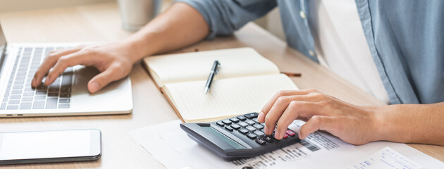 Account finance, asian young business man hand using calculator, laptop computer for calculate...