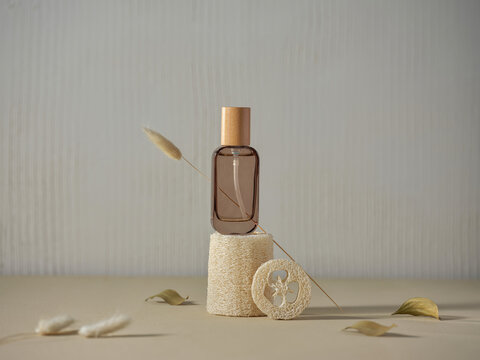Elegant perfume bottle with loofah and dried plants