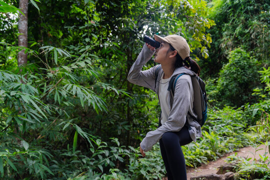 Female biologist exploring tropical forest using binoculars