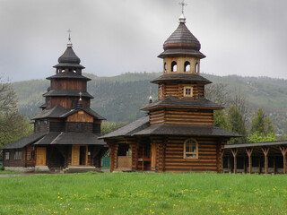 Old wooden church with shingled roof and bell tower in Carpathians, authentic Ukrainian heritage...