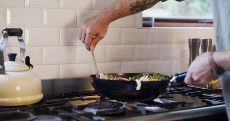 Hands, man and cooking vegetables in kitchen for healthy dinner, gourmet recipe or ingredients. Male chef, person and meal preparation in home for organic lunch, nutrition or vegetarian food on stove