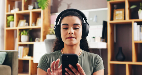 Woman, phone and headphones with music in home, scroll and mobile app for streaming in lounge....