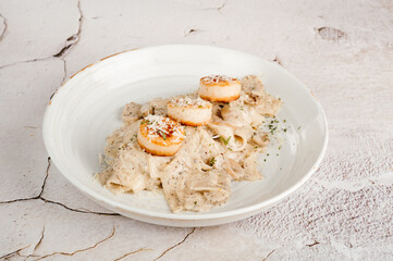 Seared Scallops on Creamy Pasta in White Plate