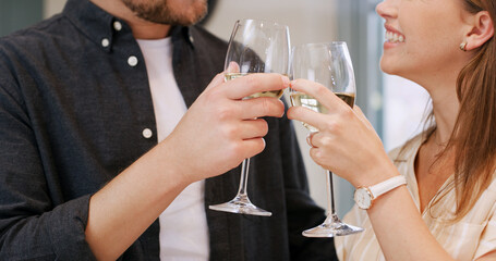 Hands, cheers and couple with wine in home to celebrate anniversary, bonding and relationship. Happy, love and man with woman toast with alcohol drink for connection, commitment and romance in house