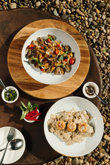 Two Pasta Dishes on Rustic Wooden Table Outdoors