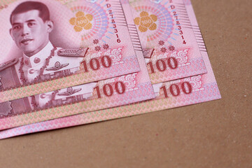 Stack of 100 Thai baht banknotes, Thai currency used in everyday transactions.