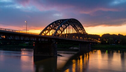 Fototapeta premium Sunset over a metal arch bridge