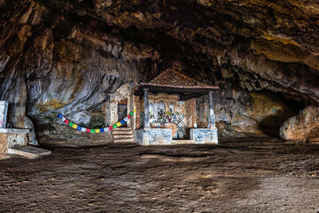 Dark interior of Lapa de Santa Margarida in Arrabida, Setubal, Portugal. Cave with small chapel of...