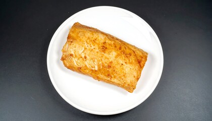 Savory baked roll on white plate