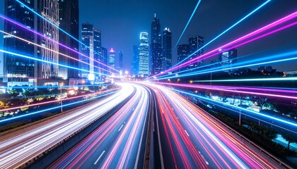 Fototapeta premium Night cityscape with vibrant light trails of speeding vehicles on a highway, showcasing modern urban architecture.