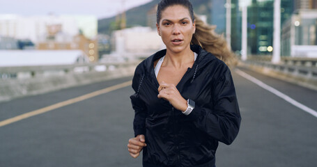 Woman, running or fitness in city with energy, cardio health or wellness outdoor. Challenge,...