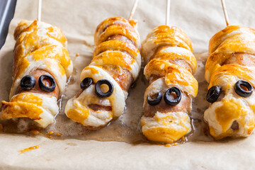 fun halloween sausage mummy snack wrapped in puff pastry close up