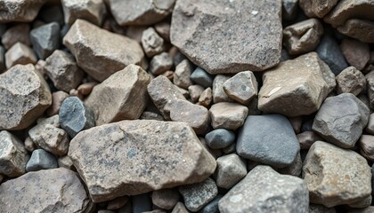 Close-up view of various sized rocks, different shades of gray and brown.