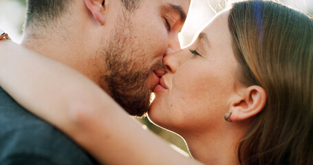 Happy, kiss and couple in nature for love, bonding and relationship together on weekend. Dating, park and man with woman with affection for commitment, romance and celebrate anniversary outdoor