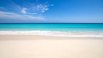 Obraz premium A beautiful beach with white sand and turquoise water under a blue sky.