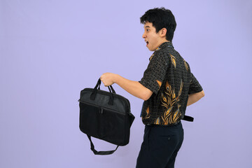 young man wearing batik shirt looking surprised 