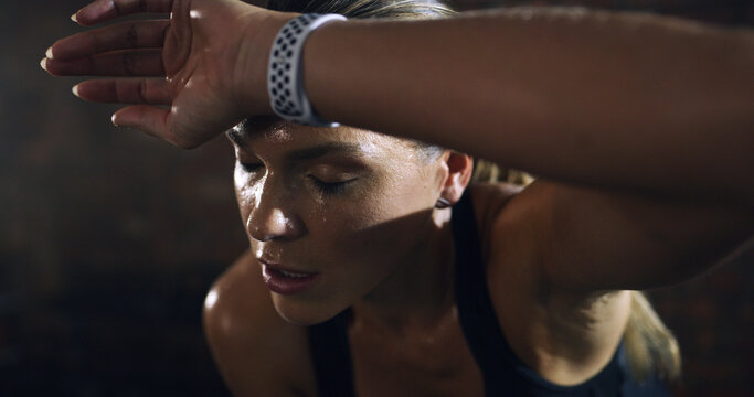 Fatigue, fitness and woman sweat in gym for workout recovery, health and wellness break. Sports, tired and exhausted athlete rest for exercise challenge, breathing and intense cardio with burnout