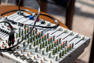 A mixing console with many controls, buttons and connectors, used for sound processing in studios...