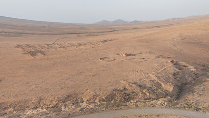 Aerial view of archaeological ruins and ancient stone structures in arid desert landscape, Fuerteventura, Canary Islands