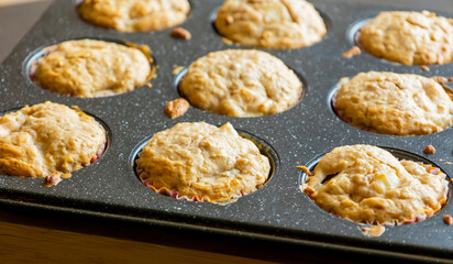 close up of golden pear muffins freshly baked in tray