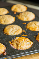 close up of golden pear muffins freshly baked in tray