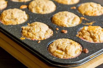 close up of golden pear muffins freshly baked in tray