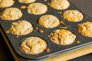 close up of golden pear muffins freshly baked in tray