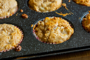 close up of golden pear muffins freshly baked in tray
